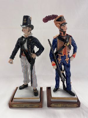 pair of figurines of two men dressed in military uniforms