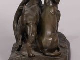 bronze statue of two dogs sitting on a base with a white background