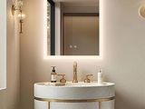 a bathroom with a sink, mirror, and toilet in it