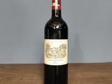 the bottle of wine is sitting on a wooden table