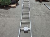 an overhead view of a long metal ladder in a warehouse