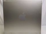 a silver apple computer sitting on a white surface