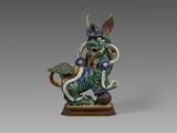 une image représentant une statue de dragon posée sur un socle en bois