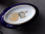 a blue and white plate with a picture of a tree on it