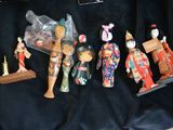 a lot of figurines that are on a black cloth