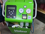 a green machine that is sitting on the ground