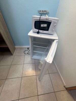 a microwave that is sitting on top of a shelf