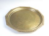 a gold tray on a white table with a white background