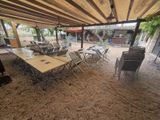 tables and chairs are set up under a covered patio area