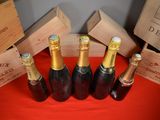 several bottles of wine are lined up on a red table