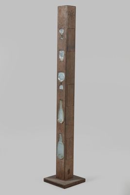 a tall wooden pole with a glass display on top of it