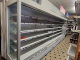 many empty shelves in a store that are full of items