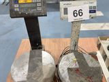 two scales sitting on a wooden table in a room