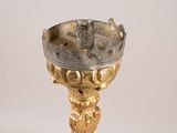 an image of a gold candle holder with a bird on it