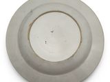 a white plate with a brown rim on a white surface