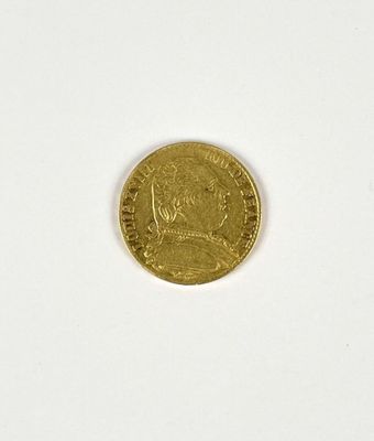 a close up of a gold coin on a white surface
