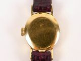 an image of a close up of a wrist watch on a white surface