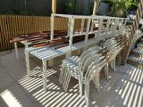 many white chairs and a table on the patio