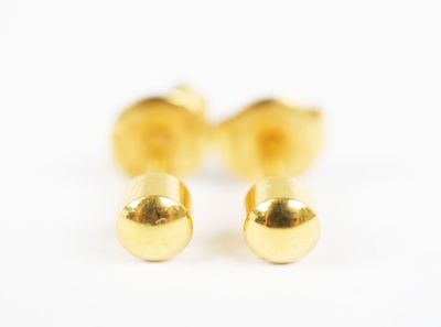 a pair of gold stud earrings on a white background