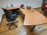 a desk with a chair and a laptop on it