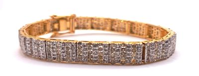 a close up of a gold bracelet with diamonds on it