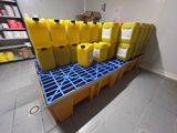 many yellow containers sitting on top of a blue pallet