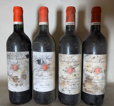 three bottles of red wine are lined up on a shelf