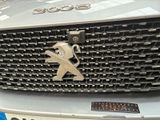 a close up of a car ' s grille with a sticker on it