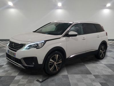 the white car is parked in a large room with a checkered floor