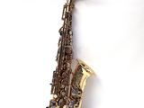 an image of a saxophone on a white surface with a white background