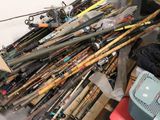a pile of fishing rods and other fishing equipment on the floor