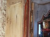 an old wooden cabinet with a mirror on top of it