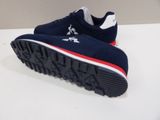 navy blue and red sneakers with white soles on a white surface