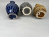 three vases sitting next to each other on a table