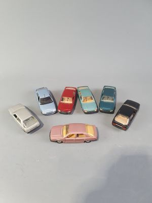 several toy cars are arranged in a circle on a white surface