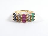 gros plan d'une bague en or avec des pierres multicolores