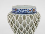 a white vase with a blue and white design on it