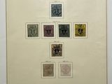 a framed picture of a group of stamps on a wall