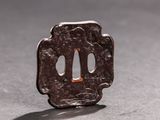 a small brown piece of metal on a table