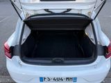 a white car with its trunk open in a parking lot