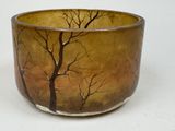 a picture of a vase with trees painted on it