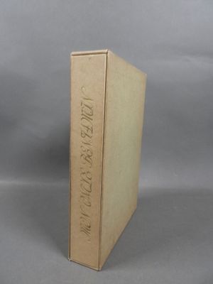 an old book sitting on top of a table next to a gray background