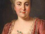 portrait of a woman in a pink dress with a flower in her hair