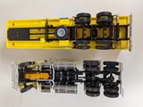 a yellow toy truck and a black toy truck
