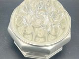 an image of a silver plate with a design on it