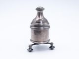 an antique silverplated bottle on a stand on a white background