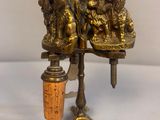 brass figurine of two dogs on a table with a cork stopper
