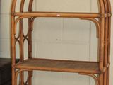 a bamboo shelf with a basket on top of it