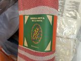 a person holding a towel that has a label on it