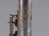 a close up of a silver plated instrument with a bell